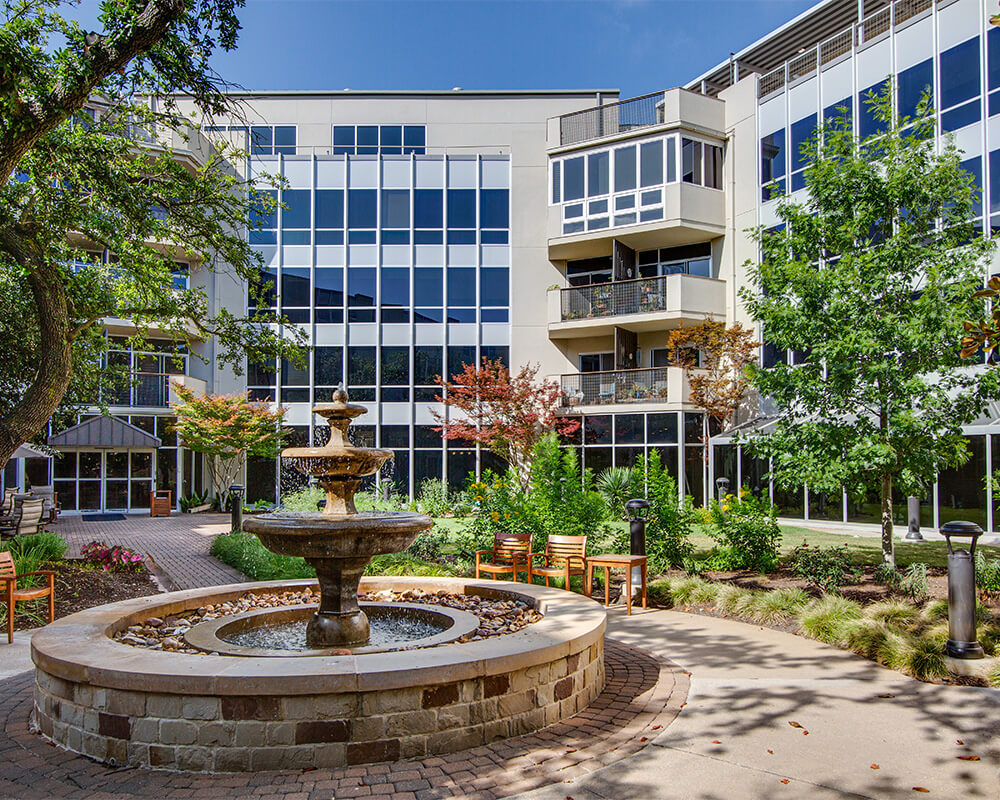 Balconies overlooking courtyard with walking path and fountain