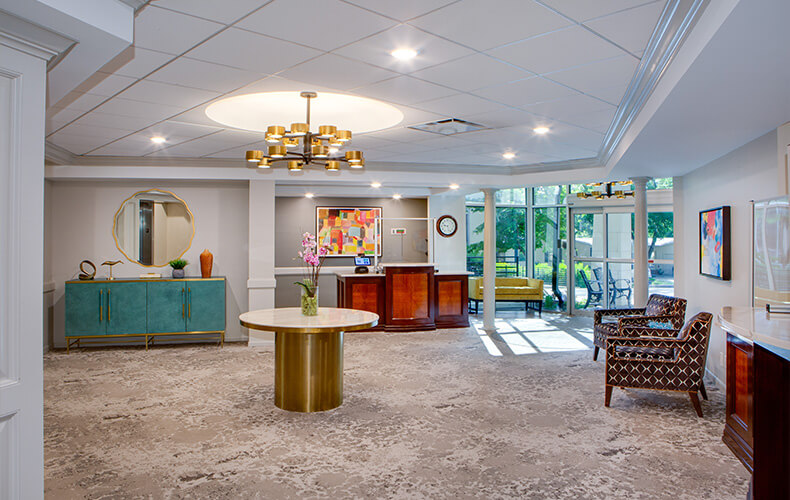 Bright lobby with modern decor and large windows in a living community.