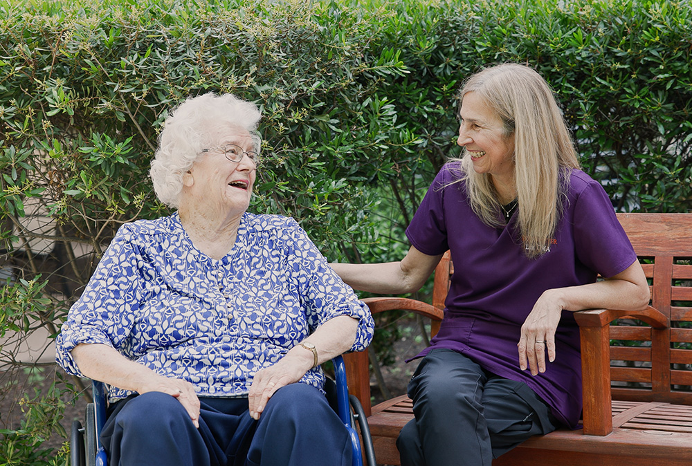 Beverly and Caregiver having a conversation outdoors