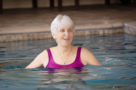 Senior woman swimming in indoor pool