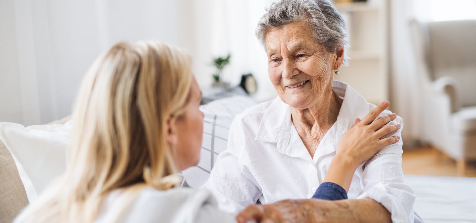 Senior woman reaching out her hand to a staff employee