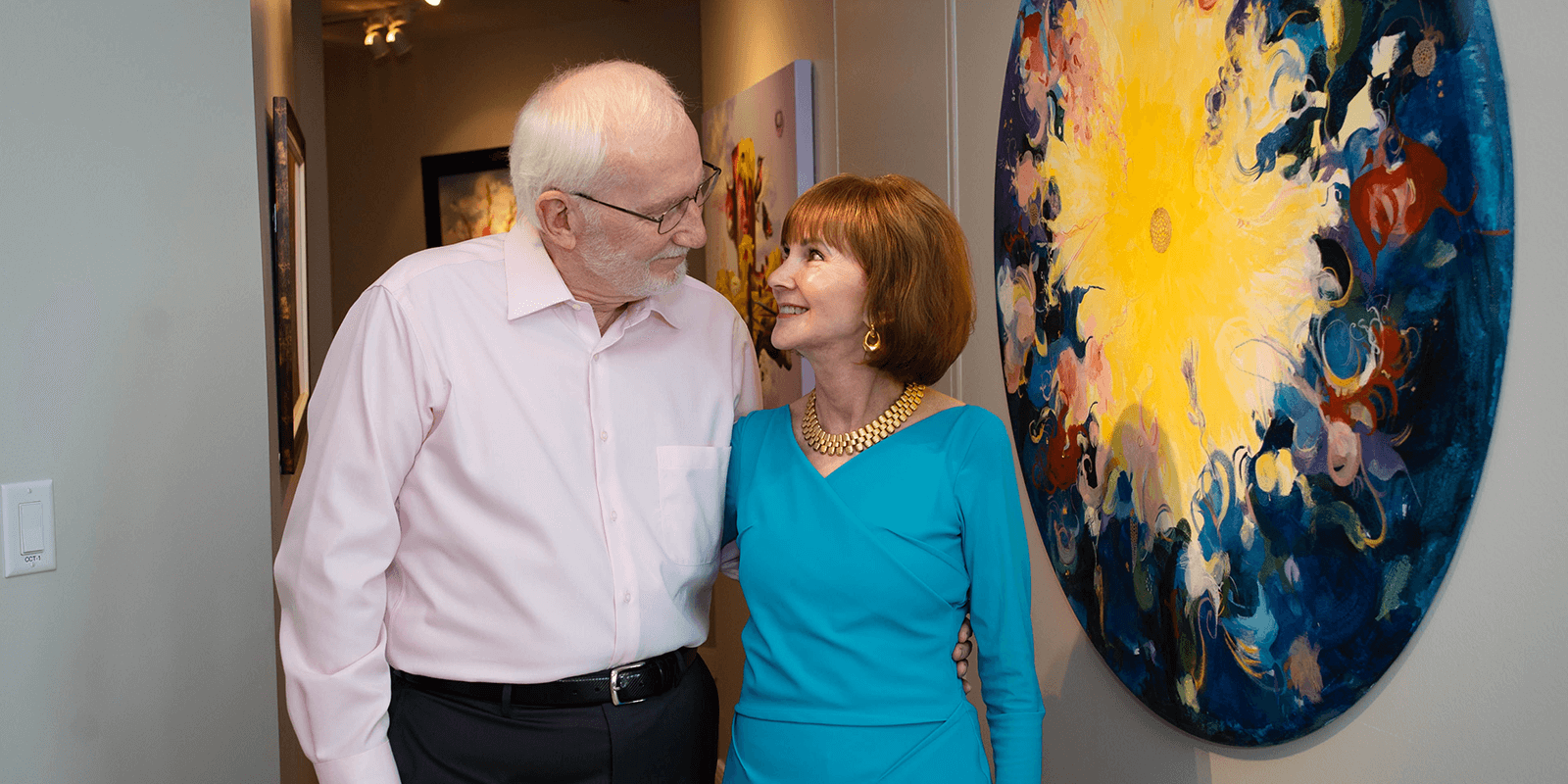 westminster-seniors-life-plan-community Senior man and women embrace each other and smile fondly at one another
